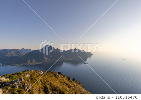 Soft light bathes Offersoykammen, overlooking tranquil Nappstraumen in Lofoten 110316470