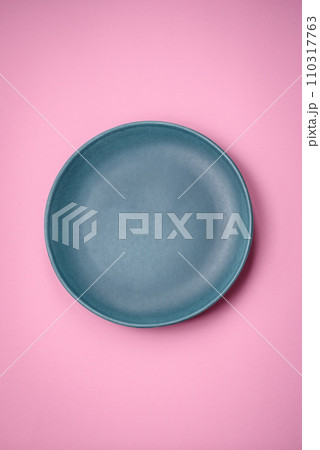 Empty round ceramic plate on a plain background, flatley with copy space Empty round ceramic plate on a plain background, flatley with copy space 110317763