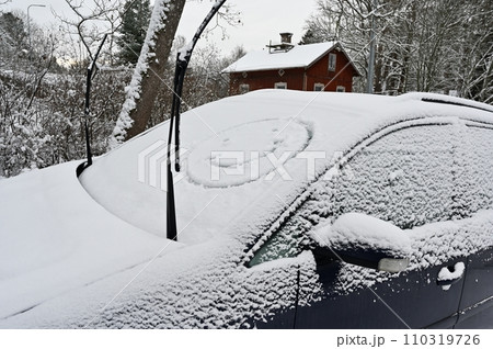 A snow covered car with a smiley face on it A snow covered car with a smiley face on it 110319726