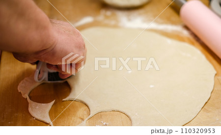 A mans hands rolling out dough A mans hands rolling out dough 110320953