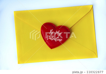 Be my Valentine text on heart shape on yellow paper envelope. Love concept Be my Valentine text on heart shape on yellow paper envelope. Love concept 110322877