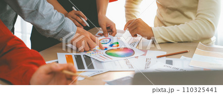 Designer team discuss about color selection from color wheel. Variegated. Designer team discuss about color selection from color wheel. Variegated. 110325441