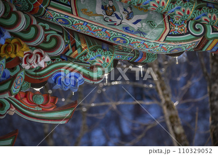 Roof of traditional Korean houses with icicles, Korean ancient architecture with icicles, snow, trees, and Korean-style houses 110329052