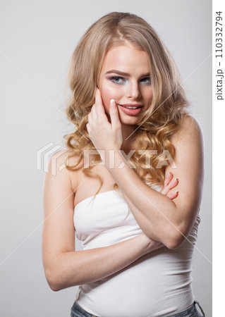 Smiling lady with curly hairdo standing on white background. Beauty woman portrait 110332794