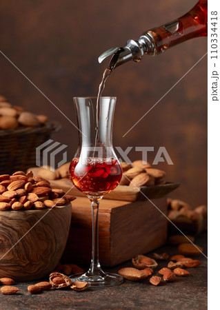 Italian liqueur Amaretto with almonds nuts. Italian liqueur Amaretto with almonds nuts. 110334418