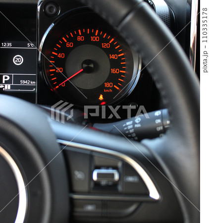 Pictogram of an unfastened seat belt before driving on the car dashboard 110335178