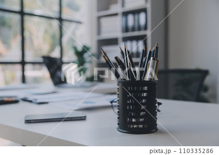 Financial analysts analyze business financial reports on a digital tablet planning investment project during a discussion at a meeting of corporate showing the results of their successful teamwork. 110335286