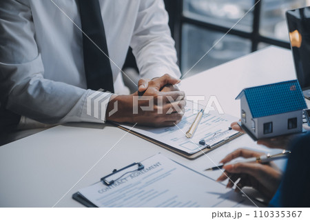 Real estate agent and customer signing contract to buy house, insurance or loan real estate.rent a house,get insurance or loan real estate or property. Real estate agent and customer signing contract to buy house, insurance or loan real estate.rent a house,get insurance or loan real estate or property. 110335367