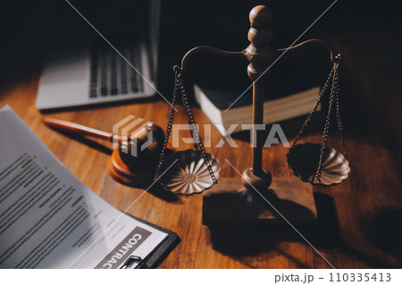 image of judge's hammer, scales lady of justice, law book, laptop computer and contract documents with pen concept of law and justice. 110335413