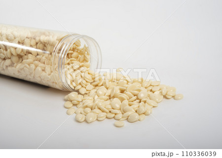 spa wax for depilation in granular form on the white background spa wax for depilation in granular form on the white background 110336039