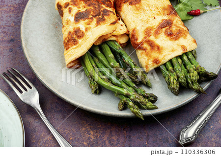 Tasty asparagus in an omelet. 110336306