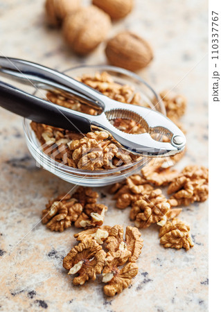 Peeled dried walnut kernels in bowl. 110337767
