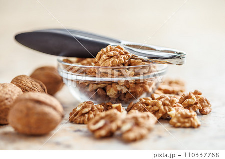 Peeled dried walnut kernels in bowl. 110337768