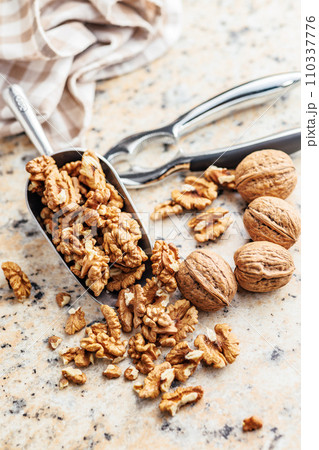 Peeled dried walnut kernels in scoop. Peeled dried walnut kernels in scoop. 110337776