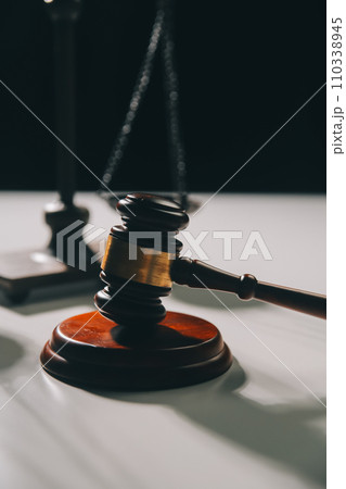 image of judge's hammer, scales lady of justice, law book, laptop computer and contract documents with pen concept of law and justice. image of judge's hammer, scales lady of justice, law book, laptop computer and contract documents with pen concept of law and justice. 110338945