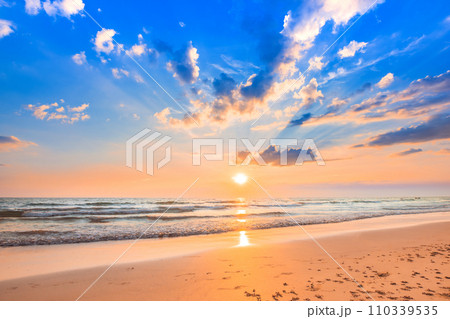 Beautiful calm sunset sky and fluffy clouds over the seascape 110339535