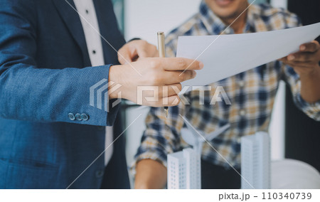 Construction and structure concept of Engineer or architect meeting for project working with partner and engineering tools on model building and blueprint in working site, contract for both companies. 110340739