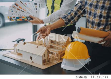 Construction and structure concept of Engineer or architect meeting for project working with partner and engineering tools on model building and blueprint in working site, contract for both companies. 110340744