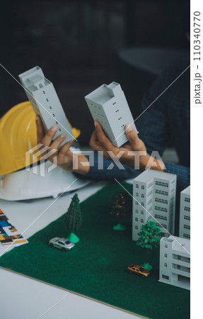 Construction and structure concept of Engineer or architect meeting for project working with partner and engineering tools on model building and blueprint in working site, contract for both companies. 110340770