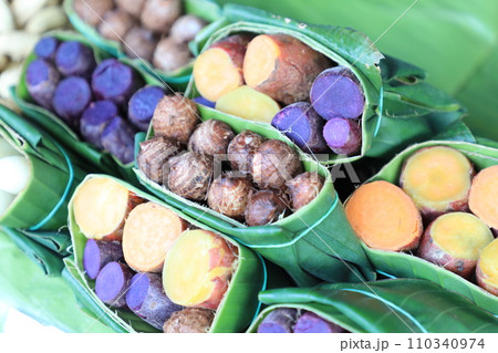 Group of waternut, chinese water chestnut, purple and yeloow sweet potato in banana leaf plate in the fresh market. 110340974