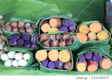 Group of waternut, chinese water chestnut, purple and yeloow sweet potato in banana leaf plate in the fresh market. 110340977