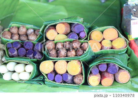 Group of waternut, chinese water chestnut, purple and yeloow sweet potato in banana leaf plate in the fresh market. Group of waternut, chinese water chestnut, purple and yeloow sweet potato in banana leaf plate in the fresh market. 110340978