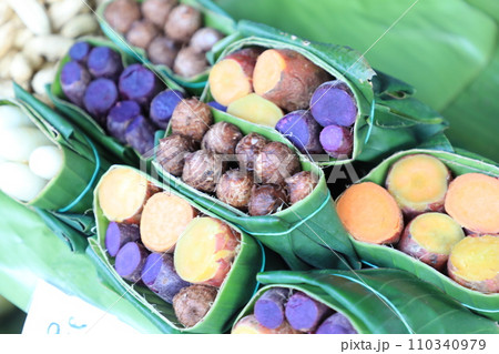 Group of waternut, chinese water chestnut, purple and yeloow sweet potato in banana leaf plate in the fresh market. Group of waternut, chinese water chestnut, purple and yeloow sweet potato in banana leaf plate in the fresh market. 110340979