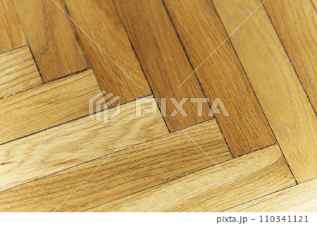Wooden parquet floor background. Old vintage parquet on the floor in the living room. Interior design concept. Wooden parquet floor background. Old vintage parquet on the floor in the living room. Interior design concept. 110341121