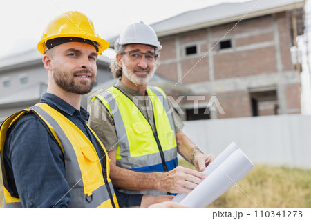 Young man worker construction engineer male working cooperate with senior project supervisor in construction site happy smile. 110341273