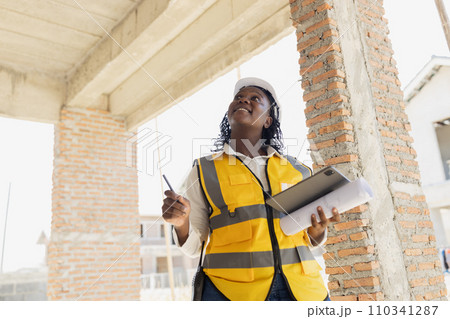 Engineer women black african professional worker working inspection quality check of construction site house building project. Engineer women black african professional worker working inspection quality check of construction site house building project. 110341287