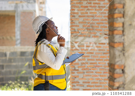 Engineer women black african professional worker working inspection quality check of construction site house building project. Engineer women black african professional worker working inspection quality check of construction site house building project. 110341288