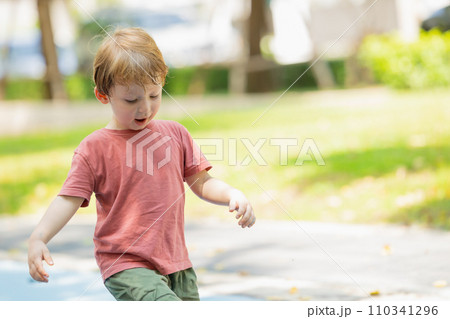 Running boy lovely healthy strong kid active playful outdoor in the park garden summer season Running boy lovely healthy strong kid active playful outdoor in the park garden summer season 110341296