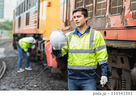 Engineer worker tired fatigue from hard working hot weather outdoor jobs with old diesel train male service staff 110341301