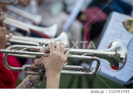 musician hands playing trumpet in school band concert 110341495