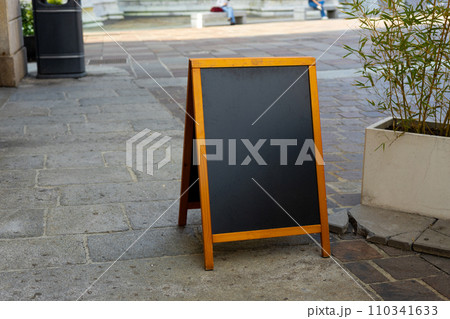 Restaurant sidewalk chalkboard sign board. Old Black Signboard on the street. Blank store signage sign design mockup isolated. . Blackboard advertising sign or customer stopper at sidewalk cafe 110341633