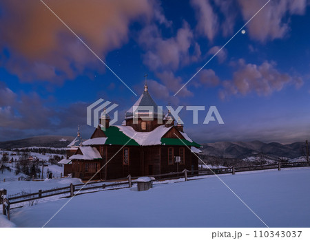 Night countryside hills, groves and farmlands in winter remote alpine mountain village. Ukraine, Voronenko. 110343037