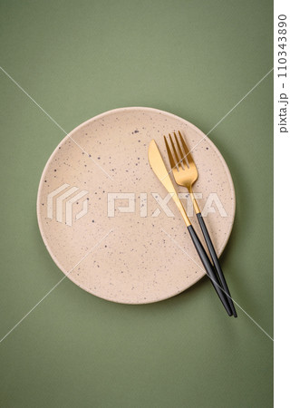 Empty round ceramic plate on a plain background, flatley with copy space Empty round ceramic plate on a plain background, flatley with copy space 110343890