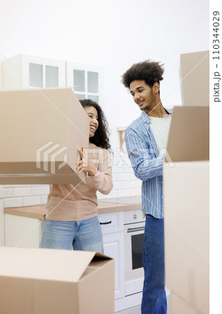 happy young people relocating to new home. purchase of residence, mortgage or rental. happy young people relocating to new home. purchase of residence, mortgage or rental. 110344029