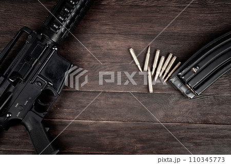Rifle and Ammunition with magazine on wooden table 110345773