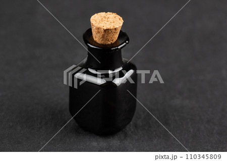 Retro vintage apothecary black glass bottle on black Retro vintage apothecary black glass bottle on black 110345809