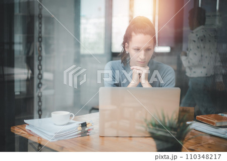 Overworked businesswoman suffering from headache and thinking how to end work. 110348217