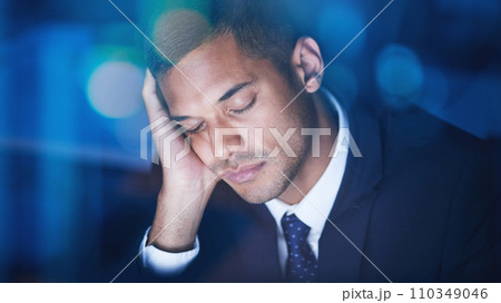 Tired, overworked and exhausted businessman sleeping while working overtime in the office at night. Fatigue, burnout and lazy corporate manager sitting at desk and taking nap in the company building. 110349046
