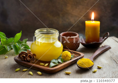 木のテーブルに置かれた瓶に入ったギーとろうそく（AI生成画像） 110349377