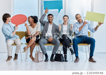 Speech bubbles, voice and vote by business people happy and sitting in an office. A diverse team of employees holding empty comment signs or icons for social media company communication 110349546