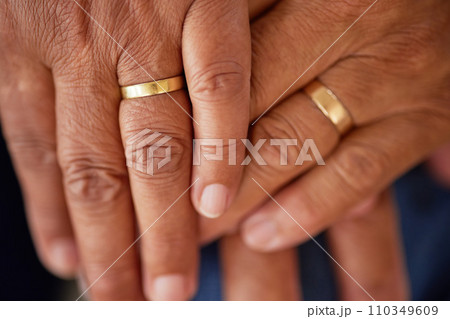 Support, trust and love of a senior married couple hands with rings and are in love for many years. Closeup of mature lovers touching and showing feelings of compassion and care Support, trust and love of a senior married couple hands with rings and are in love for many years. Closeup of mature lovers touching and showing feelings of compassion and care 110349609