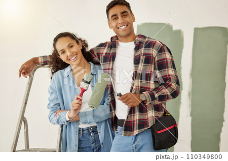 Painting, love and home with a couple doing DIY, renovation and house remodel with a paintbrush and roller. Domestic relationship and teamwork with a man and woman ready to paint a room 110349800