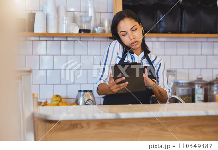Cafe manager, planning online and working on digital tablet app with internet, phone call and sales in restaurant startup. Small business store, woman entrepreneur and coffee shop hospitality worker 110349887
