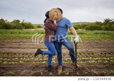 Couple kiss, agriculture farmer or garden worker on countryside field, sustainability nature or growth landscape. Bonding, romantic and fun man and woman working with environment plant and earth soil Couple kiss, agriculture farmer or garden worker on countryside field, sustainability nature or growth landscape. Bonding, romantic and fun man and woman working with environment plant and earth soil 110349936