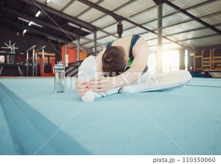 Gymnast man stretching legs at gym with flexibility fitness exercise or workout training for sports competition start. Healthy young sport athlete train for cardio, energy and body performance goal 110350060