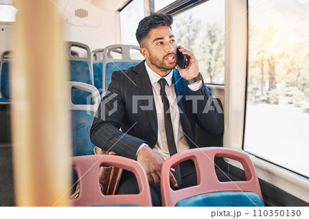 Businessman consulting on a phone call on a bus in the morning travel to work in the city. Entrepreneur, employee and worker speaking to a contact on a mobile cellphone in public transportation Businessman consulting on a phone call on a bus in the morning travel to work in the city. Entrepreneur, employee and worker speaking to a contact on a mobile cellphone in public transportation 110350130